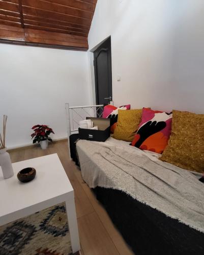 a bedroom with a bed and a white table at Adac Boutique Hotel in Bucharest