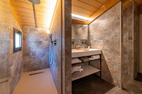 a bathroom with a sink and a shower at Via Roma 33 Tuscany Boutique Hotel & Spa - Adults Only in Stia