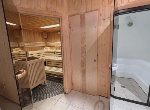 a bathroom with wooden walls and a walk in shower at Haus Wallis by stayFritz - Ski-In Ski-Out Zimmer 'garni' am Arlberg in Warth am Arlberg