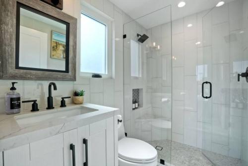 a bathroom with a toilet and a sink and a shower at NEW Luxury Beach Home I 3BR I Balcony I Firepit in San Diego