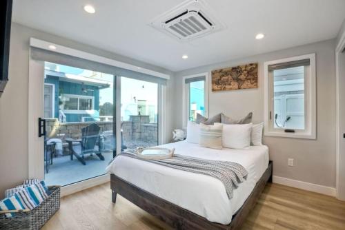a bedroom with a large bed and a balcony at Luxury Ocean Oasis 3BR I Balcony I Firepit in San Diego