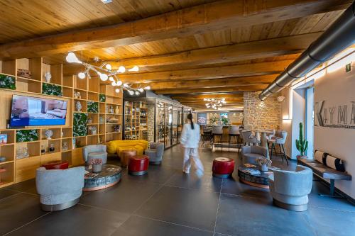 a woman walks through the lobby of a salon at Via Roma 33 Tuscany Boutique Hotel & Spa - Adults Only in Stia