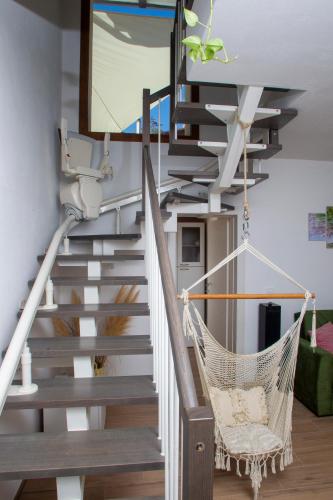 a staircase with a hammock in a living room at Villa Sumbilla, Modern, with sauna, heated jacuzzi near Tuscany in Monghidoro