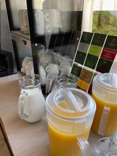 a table with two cups of orange juice and other ingredients at Hotel Lipa in Bojnice