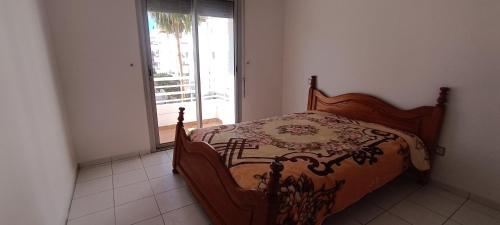 a bedroom with a bed and a window with a view at Spacious Apt in Rabat Hay Riad in Rabat