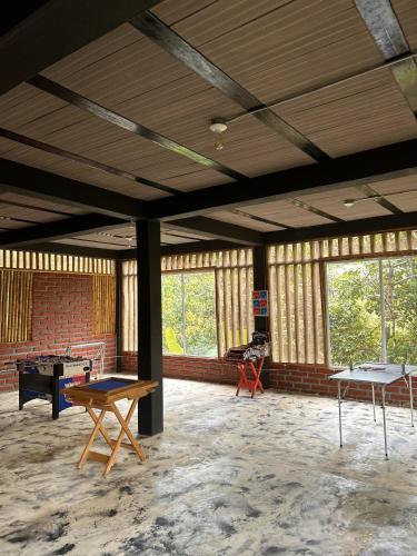 a room with ping pong tables and windows at La Veranda Hotel & Restaurant in Minca