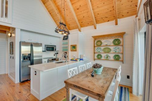 a kitchen with white cabinets and a wooden ceiling at Beautiful Lake Keowee Home with Boat Dock and Fire Pit in Seneca