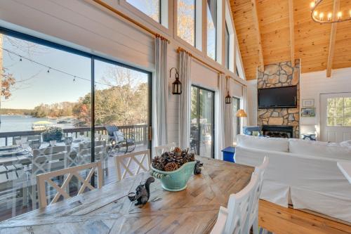 a living room with a table and a large window at Beautiful Lake Keowee Home with Boat Dock and Fire Pit in Seneca