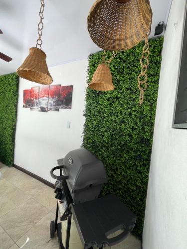 a chair in a room with a green wall at Casa Encanto Luz del Mar, Con Piscina Privada in Herradura