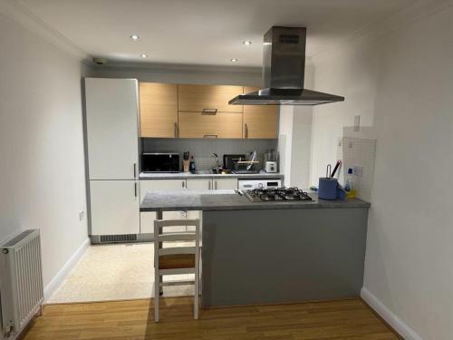 a kitchen with a counter and a stove top oven at LUXURY APARTMENTS in Dagenham