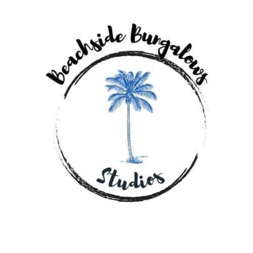 a palm tree in a circle logo at Beachside Bungalows in Batemans Bay