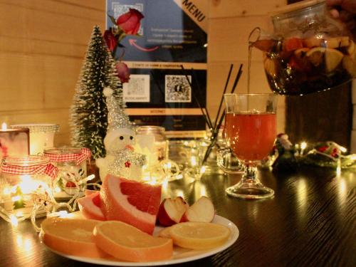 a table with a plate of fruit and a christmas tree at Bilychi - садиба у Карпатах in Bilichi