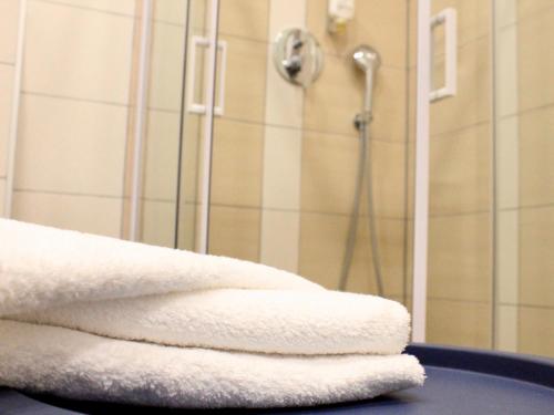 a pile of towels sitting on a table in a bathroom at Bilychi - садиба у Карпатах in Bilichi