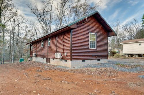 a log cabin building with a lot of dirt at Troy Cabin with River Access Fish, Kayak and More! in Troy