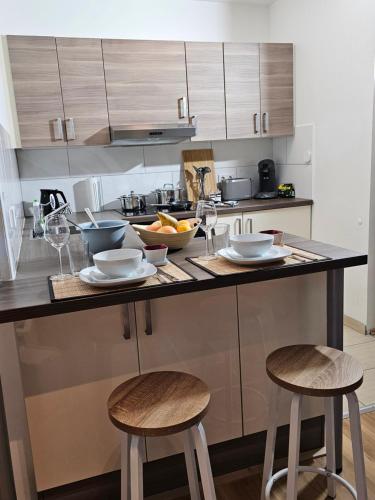a kitchen with a counter with two stools at Modern Studio near Düsseldorf Airport & Messe/Fair in Meerbusch