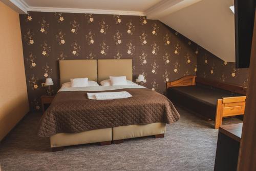 Postel nebo postele na pokoji v ubytování Hotel Lipa