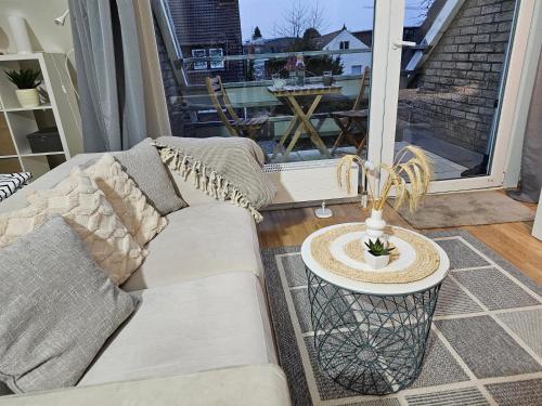 a living room with a couch and a table at Modern Studio near Düsseldorf Airport & Messe/Fair in Meerbusch