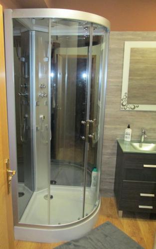 a shower in a bathroom with a sink at Pensión La Estación in Sarria