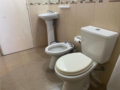 a bathroom with a toilet and a sink at Departamento Avenida in Santo Tomé