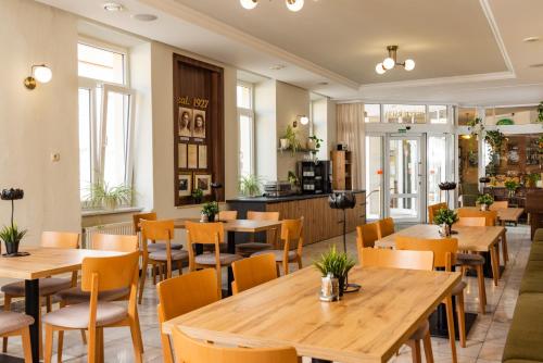 a restaurant with wooden tables and chairs at Hotel Lipa in Bojnice