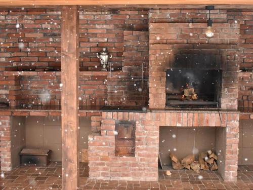 a brick wall with a fireplace in a room at Bilychi - садиба у Карпатах in Bilichi