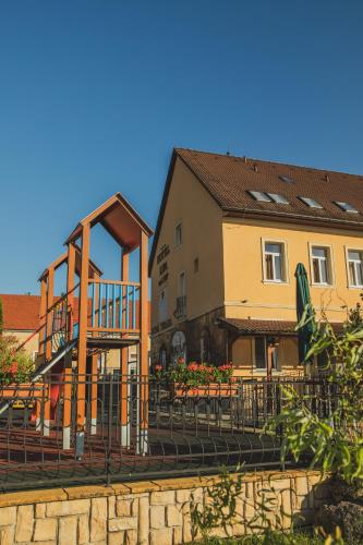 a building next to a building with a fence at Hotel Lipa in Bojnice