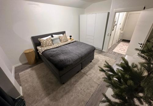 a bedroom with a bed and a christmas tree at Arctic Apartment Rovaniemi in Rovaniemi