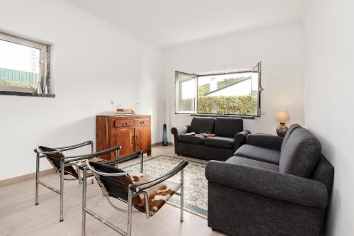 a living room with a couch and two chairs at Beachouse - Surf, Bed & Breakfast in Ericeira