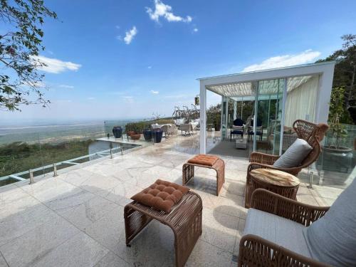 a patio with furniture and a view of the ocean at Atmã Pousada in Chapada dos Guimarães