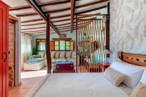 a bedroom with a bed and a living room at Las Casas de la Rueda - La Casita in Santa Lucía