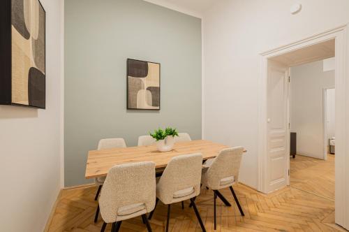 a dining room with a wooden table and chairs at Charming APT perfect for 4-6 tram, self-checkin in Vienna