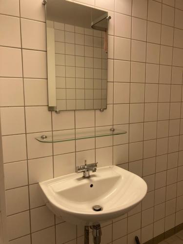 a bathroom with a sink and a mirror at 400 m from metro modern cozy apartment in Copenhagen