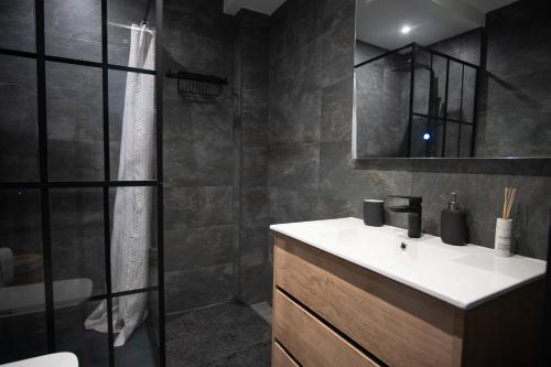 a bathroom with a sink and a shower at EDELWEISS HOUSE - Parking y Wifi GRATIS in Sierra Nevada
