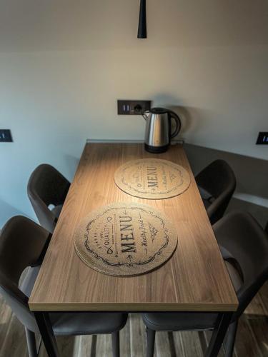 a wooden table with a pitcher on top of it at Bel Fiore Deluxe Apartment in Genova