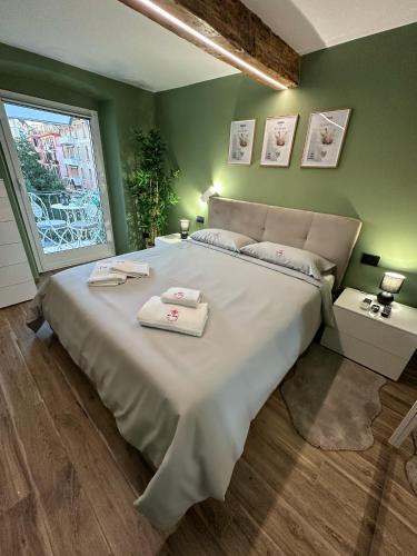 a bedroom with a large bed with two towels on it at Bel Fiore Deluxe Apartment in Genova