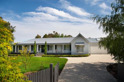 a house with a fence in front of it at Peahen House in Trentham
