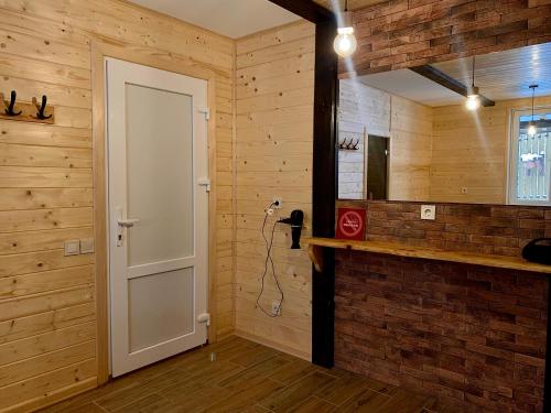 a room with a white door and a mirror at Bilychi - садиба у Карпатах in Bilichi