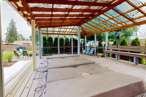 a pergola on a deck with a bench at Marysville Modern Oasis in Marysville