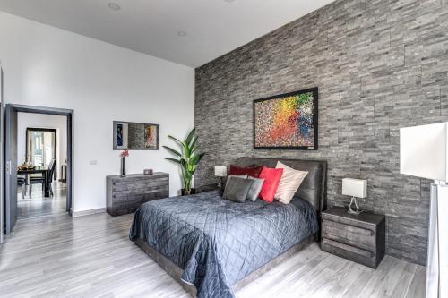 a bedroom with a brick wall and a bed at 1000 Suites in Naples