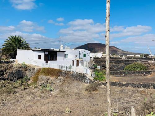 una casa bianca sul fianco di una collina di Campo y lava a Tías