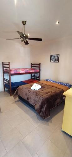 a bedroom with a bed and a ceiling fan at ENCUENTRO LA ÑATA in Amaicha del Valle