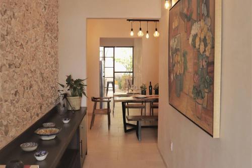 a living room with a painting on the wall at Casa María Dolores, Barrio San Sebastián in Mérida