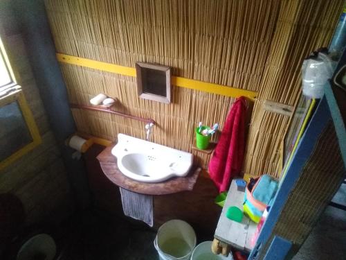 a small bathroom with a sink and a mirror at Casa de madera en playa de Cabo Polonio con dos ambientes in Cabo Polonio