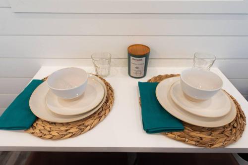 two bowls and plates on top of baskets on a table at New Southwest Shipping Container-In Alpine in Alpine