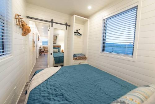 a bedroom with a bed in a room with a window at New Southwest Shipping Container-In Alpine in Alpine