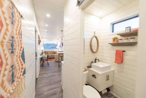a bathroom with a toilet and a sink at New Southwest Shipping Container-In Alpine in Alpine