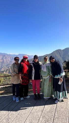 a group of people posing for a picture on a mountain at Ananta Prana in Mussoorie
