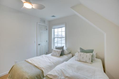 two beds in a white room with a window at Airy West Cape May Cottage Less Than 1 Mi to Beach! in Cape May