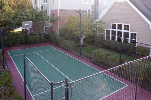 a tennis court in the backyard of a house at Residence Inn Providence Coventry in West Greenwich