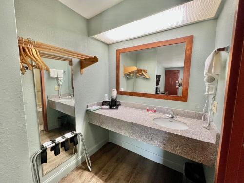 a bathroom with two sinks and a mirror at Econo Lodge in Sanford